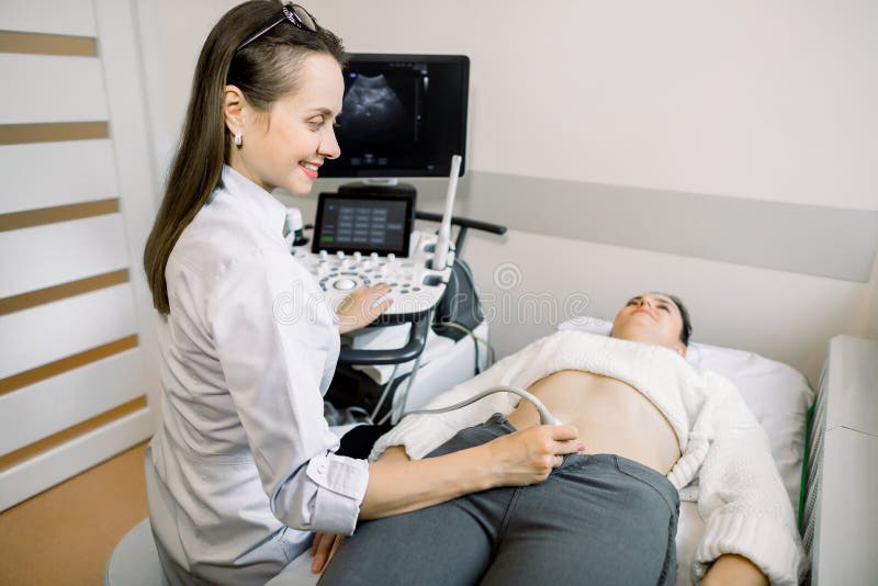 Female Doctor Performs Ultrasound Examination Of Pelvic Organs Of Her 