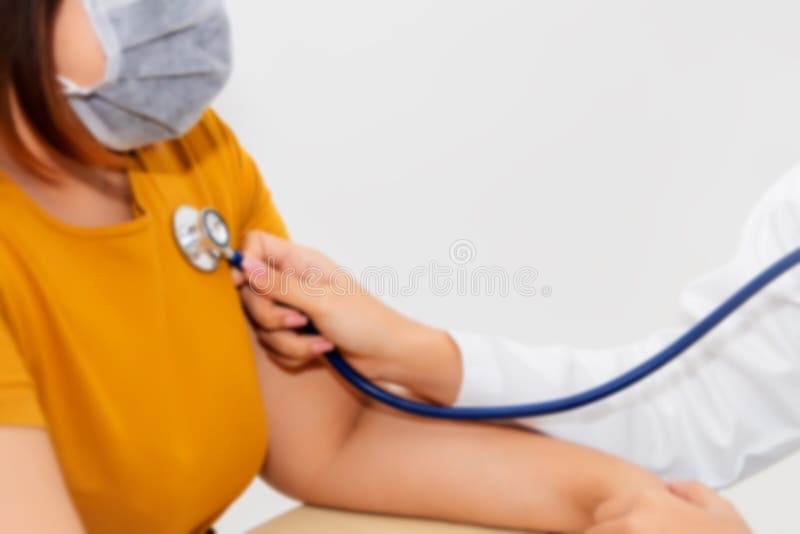 Female doctor`s hand using a stethoscope Check the pulse of obese patients wearing masks.