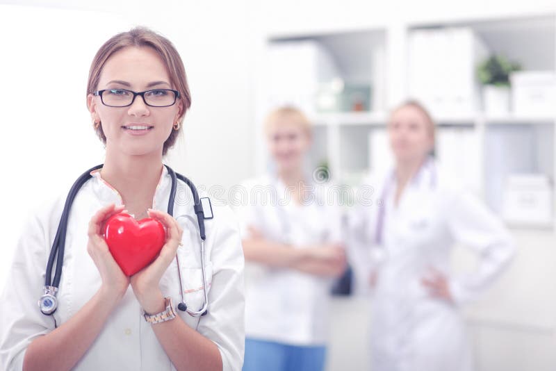 Female doctor with stethoscope holding heart in her arms. Healthcare and cardiology concept in medicine stock images Female doctor with stethoscope holding heart in her arms. Healthcare and cardiology concept in medicine stock images