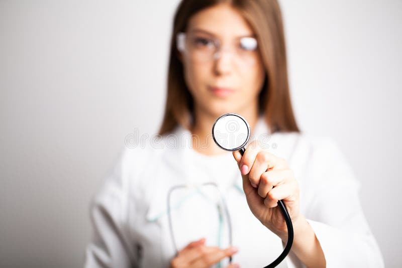 Female Doctor In A White Coat Holding A Stethoscope Stock Photo Image