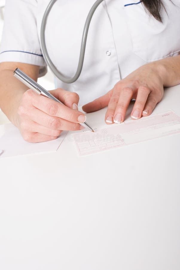 Female doctor writing a prescription royalty free stock image