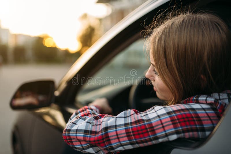 Female driver beginner looks out of the car window royalty free stock photography Female driver beginner looks out of the car window royalty free stock photography