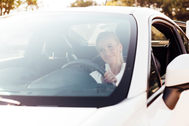 Female Driver Behind the Wheel of a White Car Stock Photo Image of