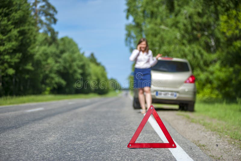 Female driver after breakdown calling to a car assistance