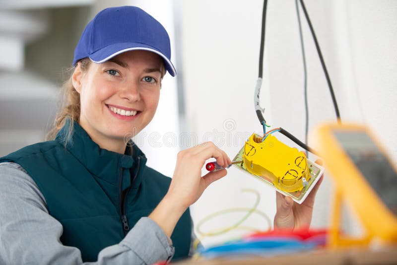Female Electrician Happy at Work Stock Photo Image of female, wall