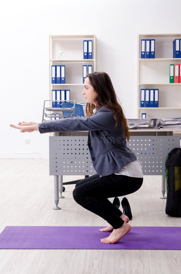 The Female Employee Doing Sport Exercises in the Office Stock Image