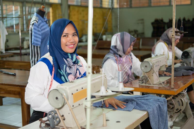 Female Employees in Headscarves Smile Looking at Cameras while Working ...