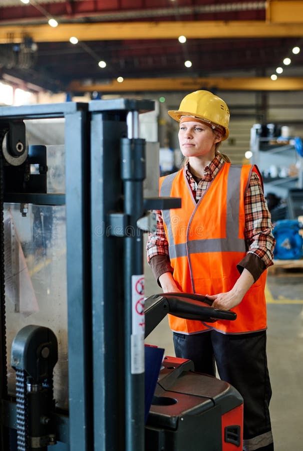 Female Engineer Looking Forwards while Standing in Front of Electric
