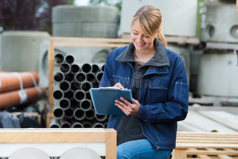 Female engineer standing outside recycling factory stock images