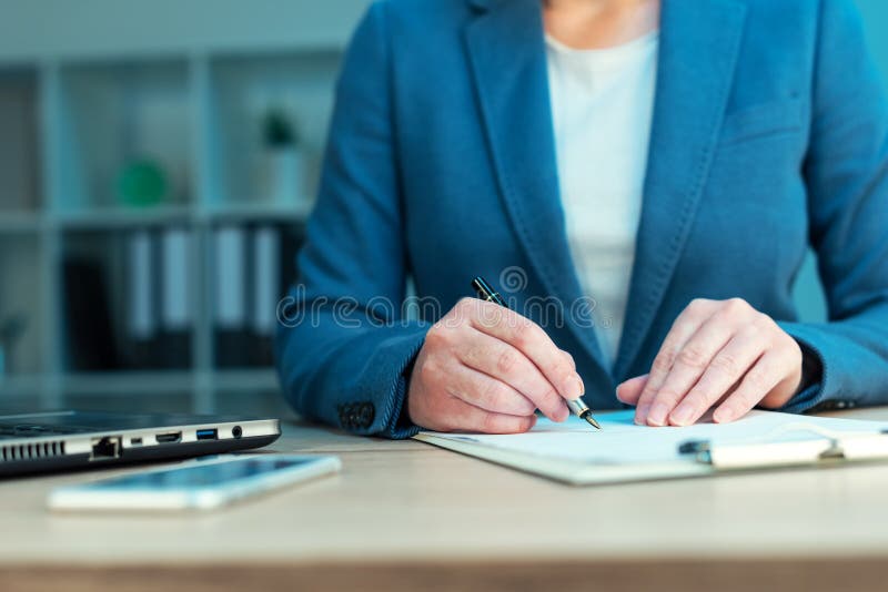 Female executive approves business plan and signing document stock images Female executive approves business plan and signing document stock images