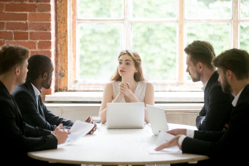 Female executive coaching group of corporate employees during br