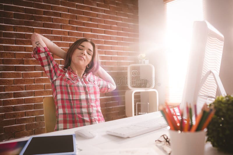 Female executive relaxing at her desk stock images Female executive relaxing at her desk stock images