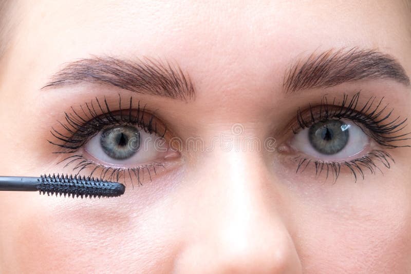 Female Eyes with Mascara Brush. Female Eyes with Long Eyelashes and a