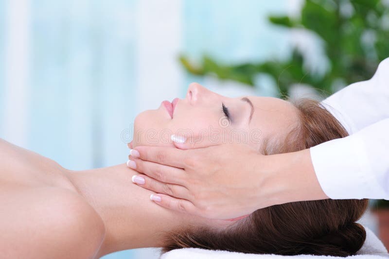 Female face massage stock photography