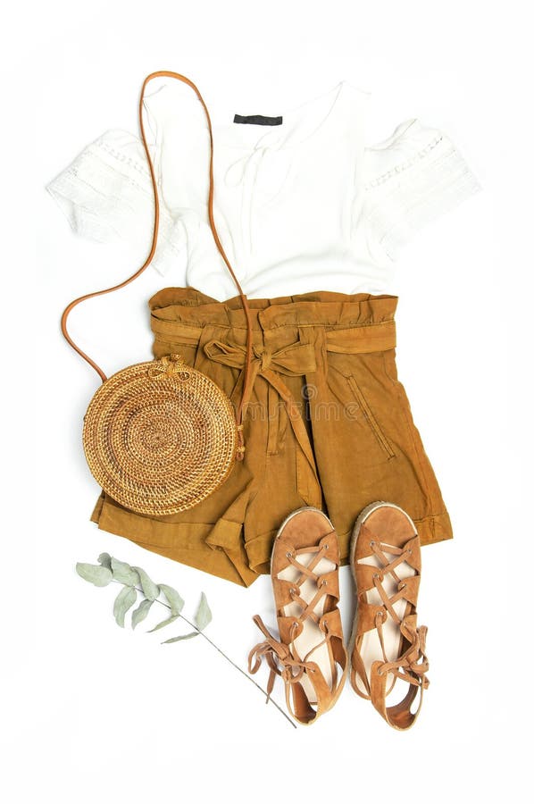 Female fashion background. Stylish trendy feminine summer clothing set. Shorts, white jacket, sandals, round rattan bag, sprig stock photo Female fashion background. Stylish trendy feminine summer clothing set. Shorts, white jacket, sandals, round rattan bag, sprig stock photo