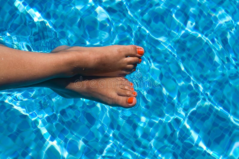 Female feet in pool