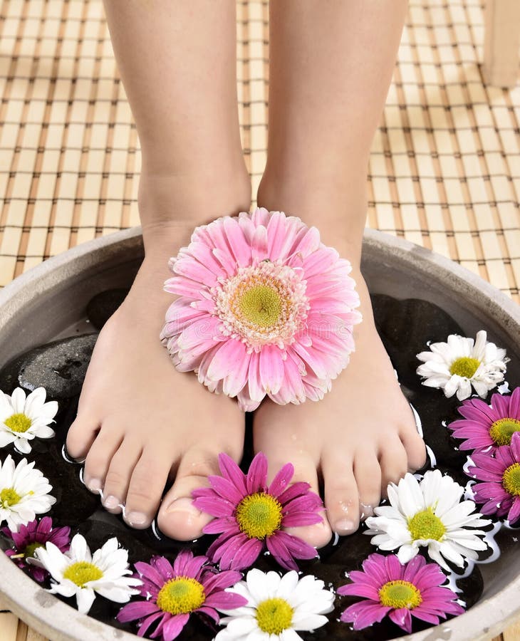 Female feet at spa salon on pedicure procedure