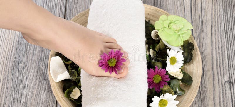 Female feet at spa salon on pedicure procedure