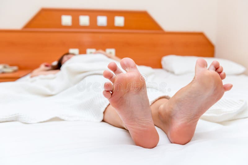 Feet And Stretch Lazily In Bedroom After Waking Up,Close Up Of Woman