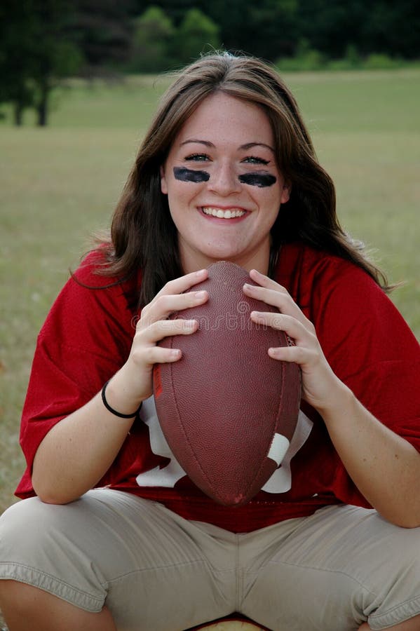 Young woman holding football and ready for game. Young woman holding football and ready for game