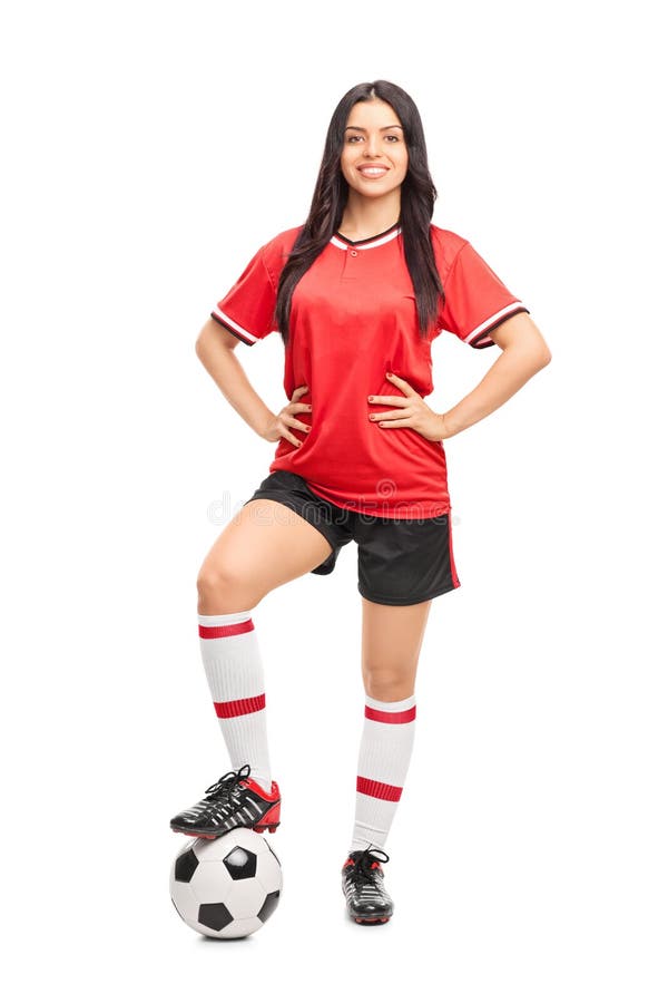 Full length portrait of a female football player in a red jersey isolated on white background