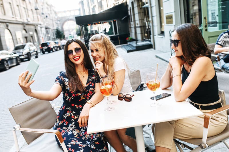 Young Beautiful Girls Takes Selfie In A Cafe Outdoor Stock Image Image Of Girlfriends Group 