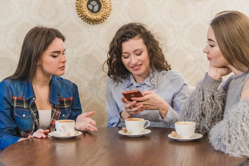Three girls with cups stock image. Image of indoors, everyday