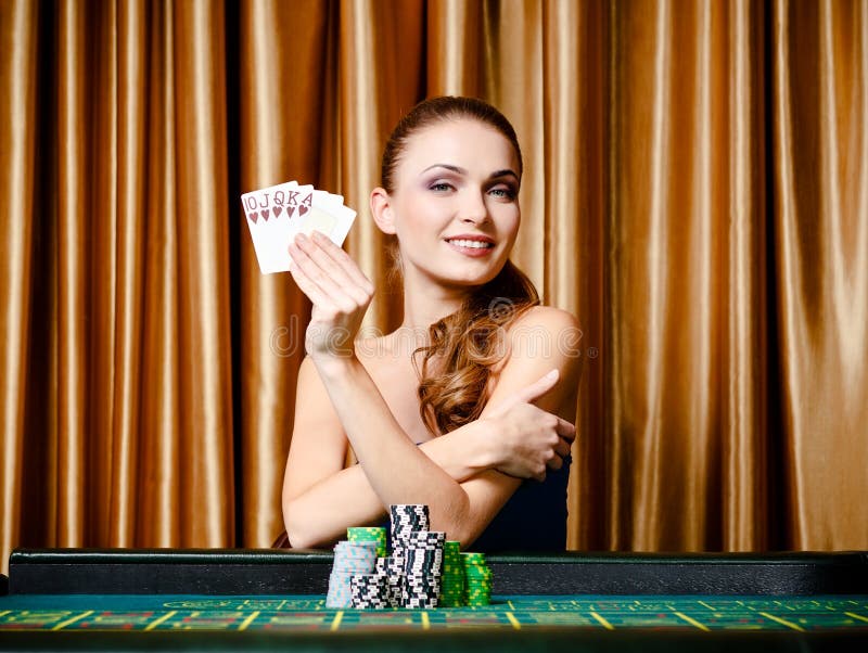 Female gambler with cards at the poker table