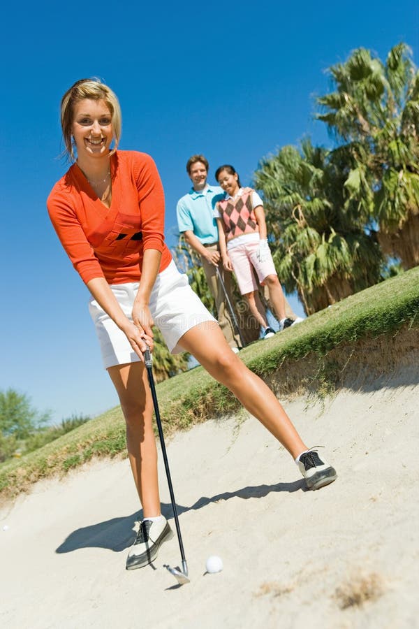 Female golfer hitting ball