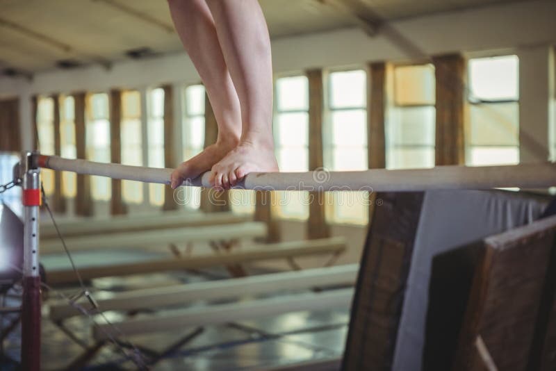 Female gymnast practicing gymnastics on the horizontal bar royalty free stock photo Female gymnast practicing gymnastics on the horizontal bar royalty free stock photo