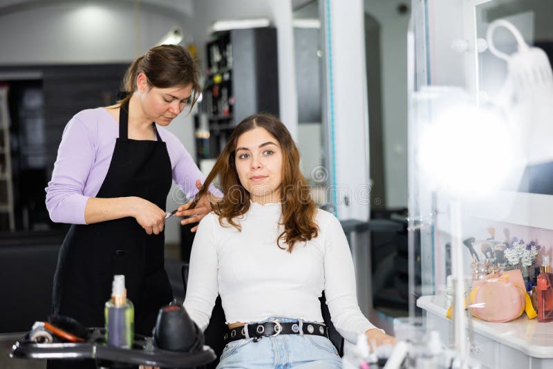 Female Hairdresser Cuts the Hair of a Young Woman Client Stock Photo ...