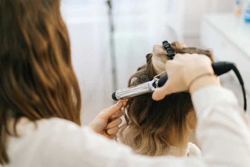Female Hairdresser Making Hairstyle for Young Woman with Blonde Hair in  Salon. Stock Photo - Image of attractive, haircut: 182317558