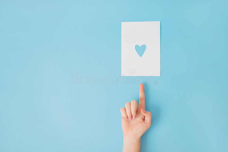 Female hand on a blue background pointing up. royalty free stock images Female hand on a blue background pointing up. royalty free stock images