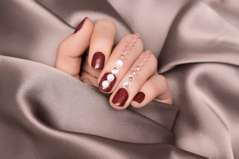 Female hands with red and white nail design. Glitter red and glossy white  nail polish manicure. Female model hands on red fabric background. Stock  Photo | Adobe Stock