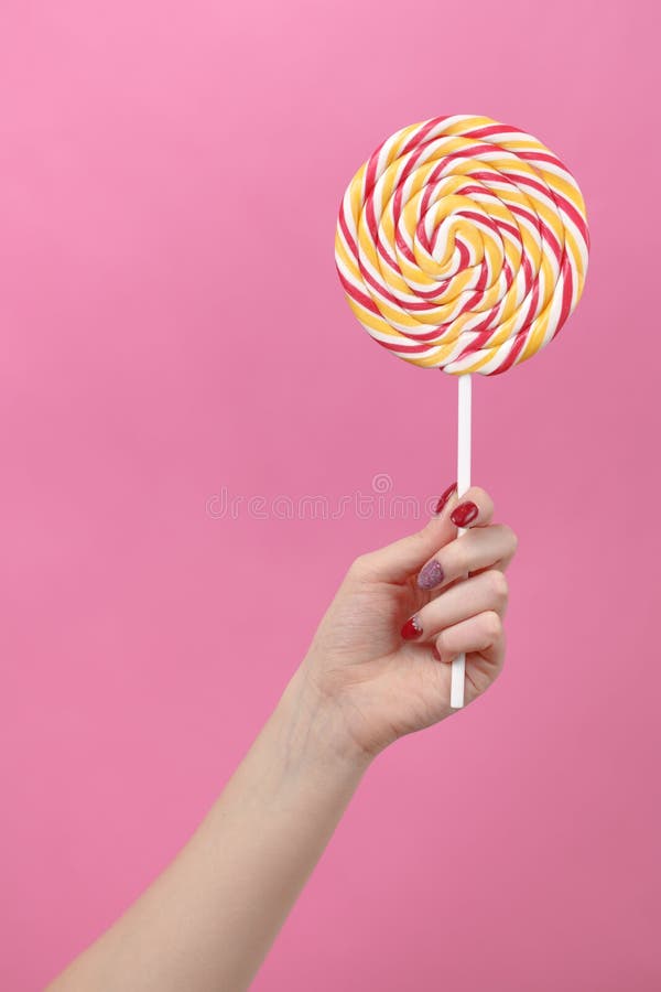Female Hand Hold Lolipop on Pink Background Stock Image - Image of hold ...