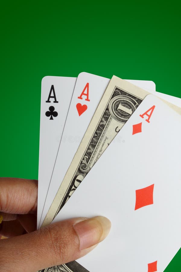 Gambling Concept: Female hand holding three aces and one dollar note. Gambling Concept: Female hand holding three aces and one dollar note