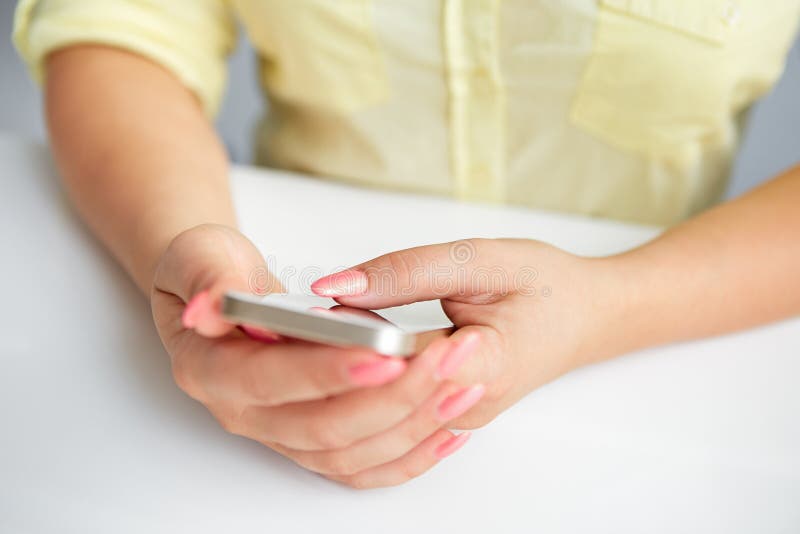 Female hand holding a cell phone