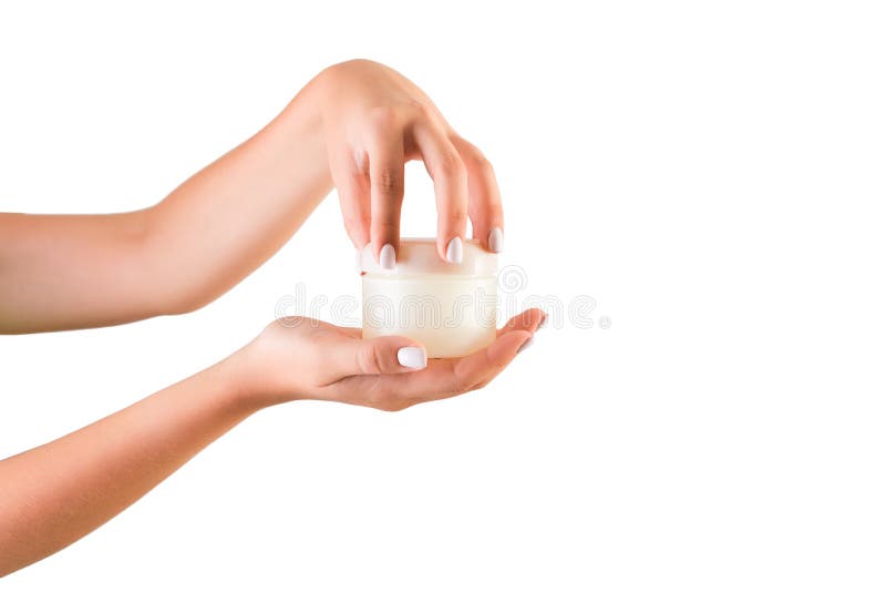 Female hand holding cream bottle of lotion isolated. Girl opening jar cosmetic products on white background stock photography Female hand holding cream bottle of lotion isolated. Girl opening jar cosmetic products on white background stock photography