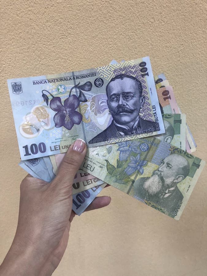 A hand holding Lei banknotes that is currency of Romania