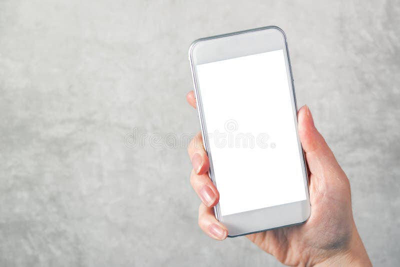 Female hand holding mobile phone with blank mock up screen