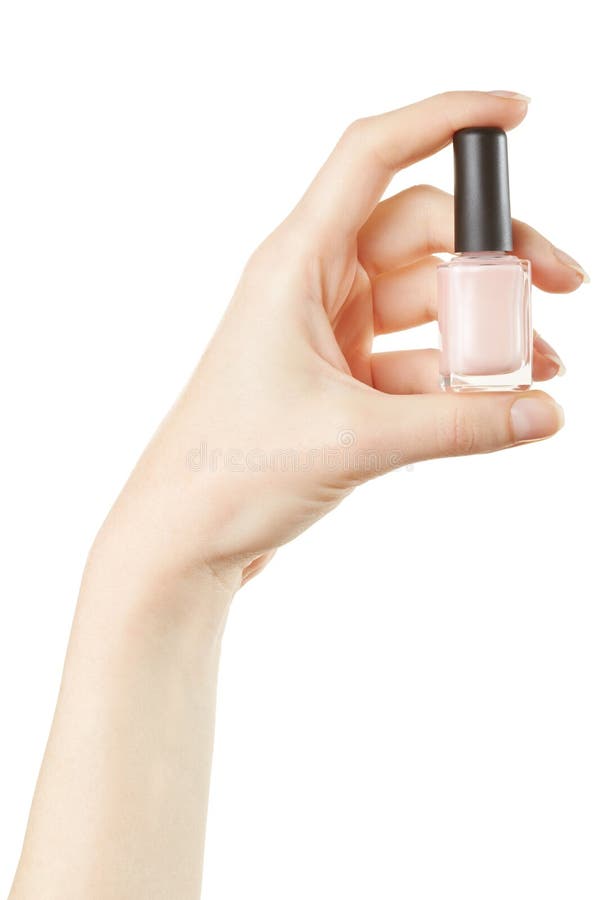 Female hand holding pink nail polish bottle