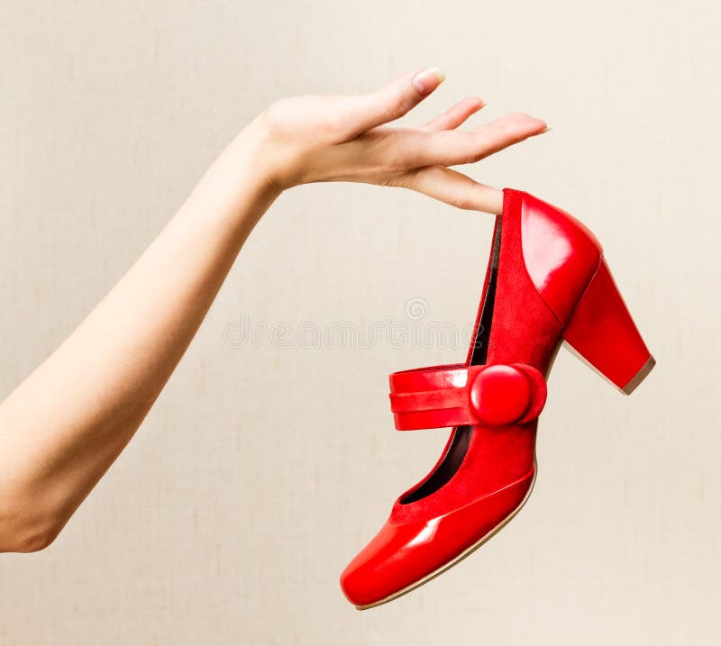 Female Hand Holding Red Varnish Shoes on a High Heel. Stock Photo ...