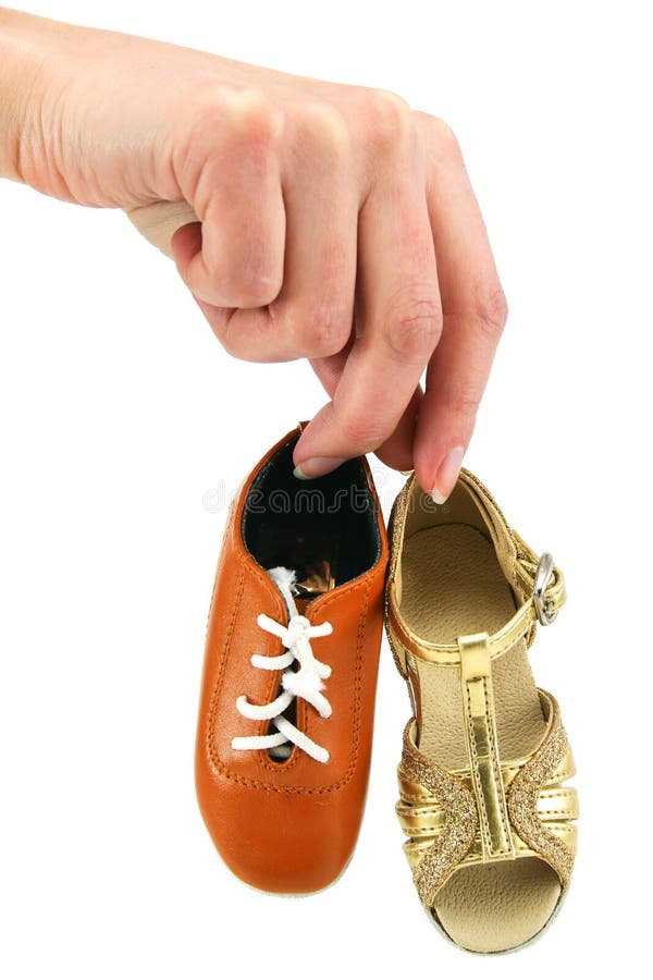 Female hand holds tiny dancing shoes
