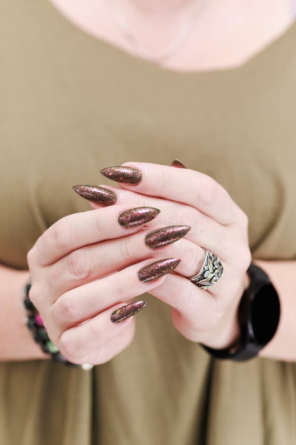 Female Hand with Long Nails and a Bottle of Green Brown Nail Polish Stock  Photo - Image of feminine, finger: 257305394