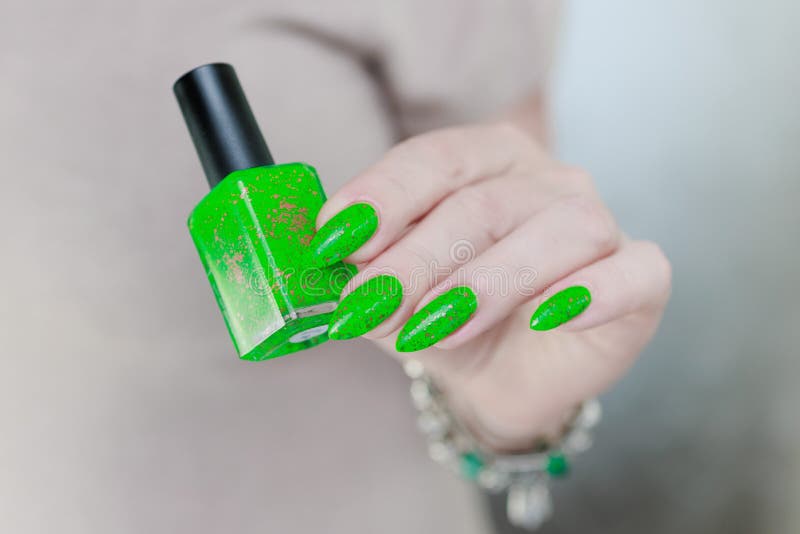 Female hand with long nails and neon green manicure Stock Photo - Alamy