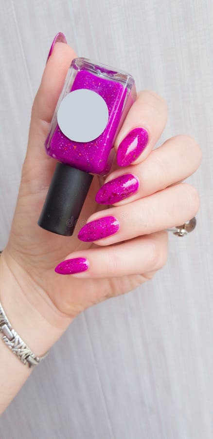 Female Hand with Long Nails and Pink Fuchsia Manicure Holding a Bottle  Stock Photo - Image of feminine, glass: 141653366