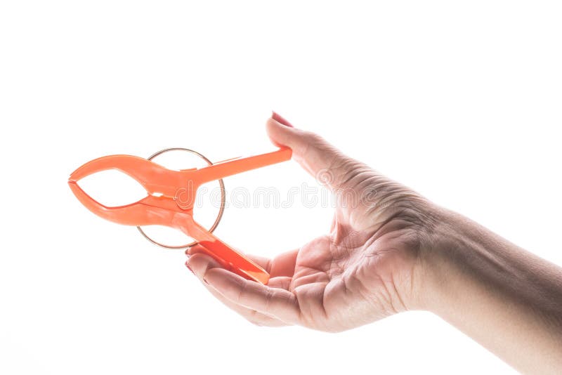 Female hand with manicure holds plastic clip on a