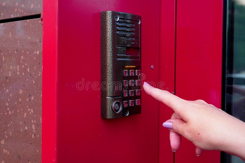 Female hand opens electronic lock by pressing buttons. Security Keyboard Control opens the office. Modern intercom stock images