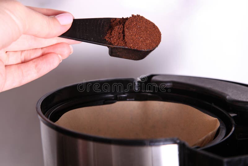 Female Hand Pours Ground Coffee into Drip Coffee Maker Stock Image