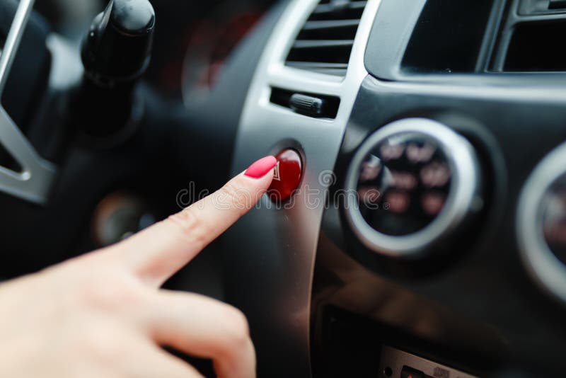 The female hand presses the button to turn the alarm into the car. royalty free stock photography The female hand presses the button to turn the alarm into the car. royalty free stock photography